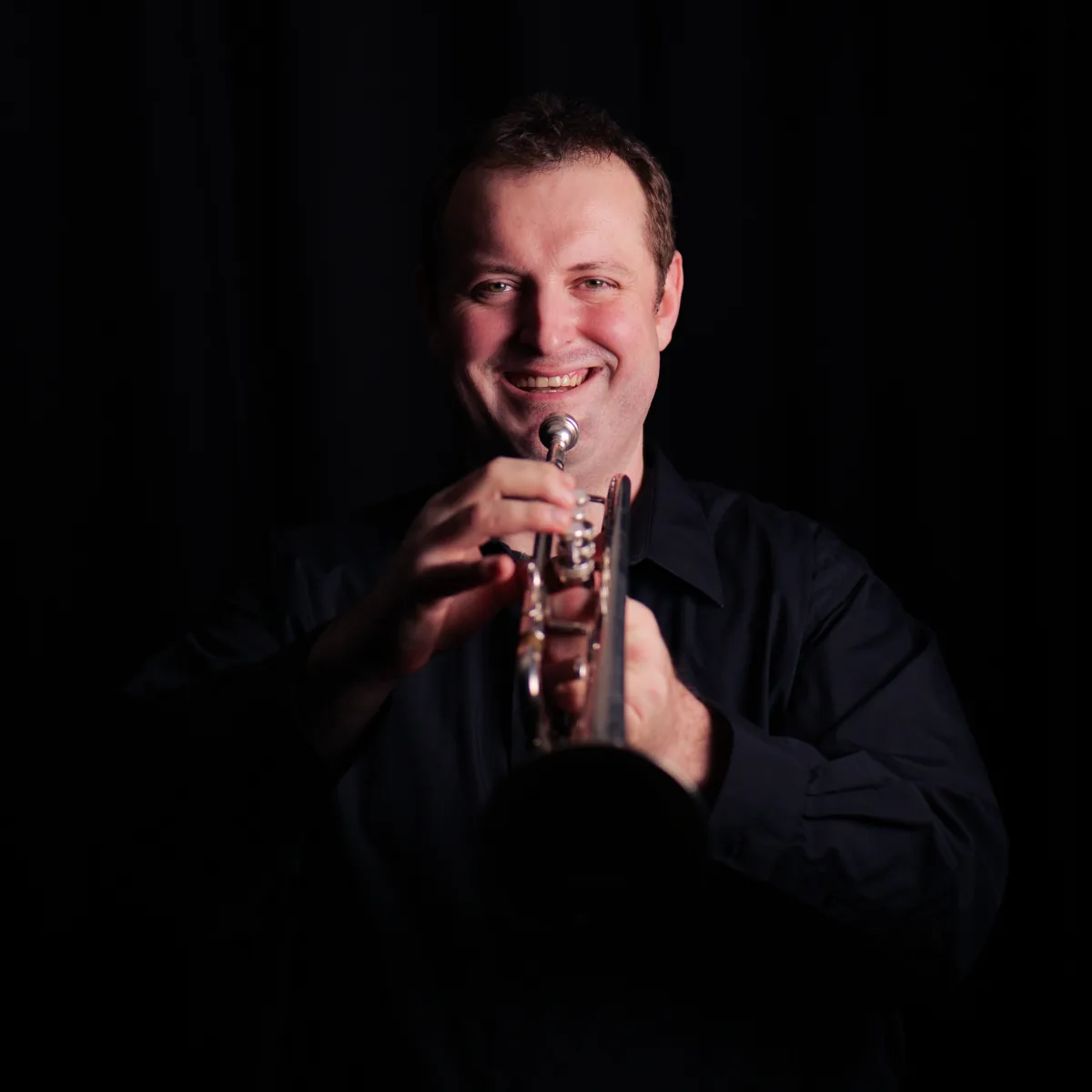 Mathew Harwich holding his trumpet